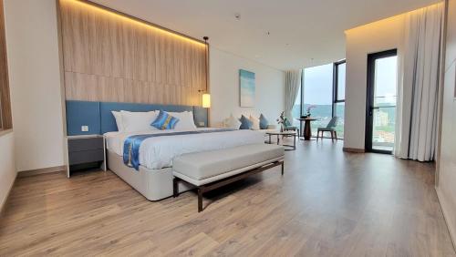 a large bedroom with a large bed and a table at A la carte in Ha Long