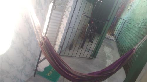 a hammock in front of a room with a bike at Beach House in Salinas da Margarida