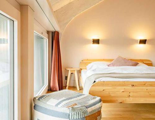 a small bedroom with a bed and a window at Silo Design & Boutique Hostel Basel in Basel