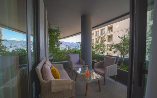 a balcony with chairs and a table on a balcony at Amare Luxury Apartments in Budva