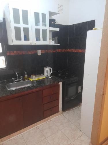 a kitchen with a sink and a stove at Apart incone in Formosa