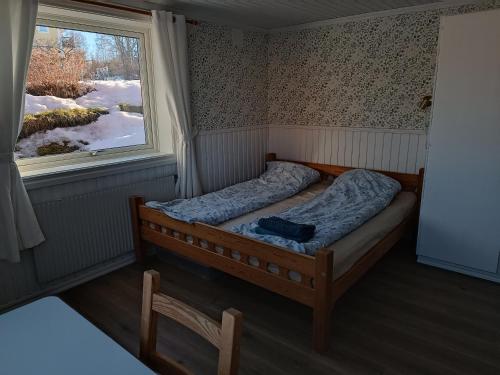 a small bed in a room with a window at Large apartment with sauna in central Mora in Mora