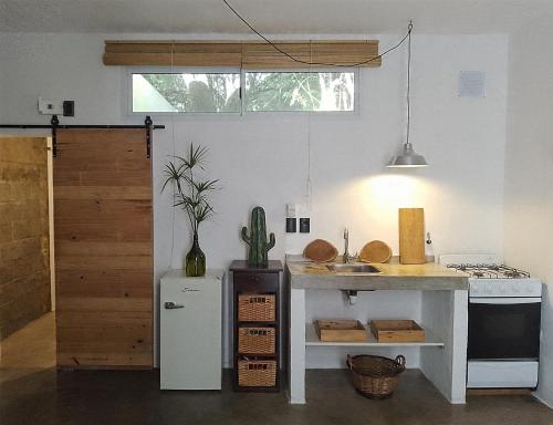 a kitchen with a counter and a sink in a room at Aloja Merlo in Merlo