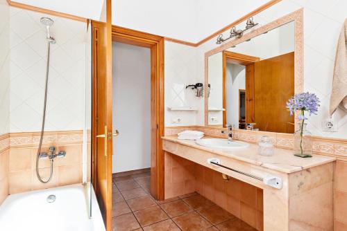 a bathroom with a sink and a shower and a mirror at Villa Miguel Dos in Cala'n Bosch