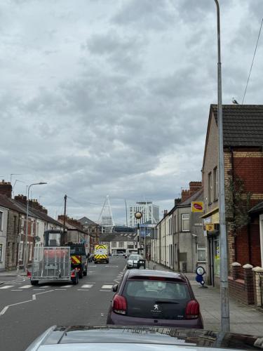 a city street with cars parked on the side of the road at Cardiff Grangetown Stylish 3Bed House. in Cardiff