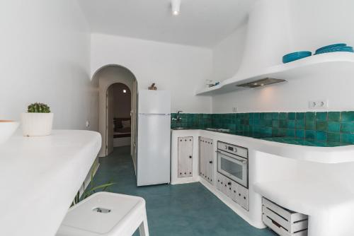 una cocina con armarios blancos y azulejos verdes en Home2Book Stylish Oasis Manrique City Center, en Las Palmas de Gran Canaria