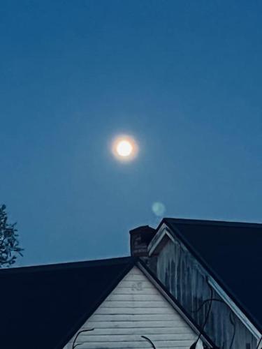 a moon in the sky over a house at Huset i gränden - granne med havet in Trelleborg