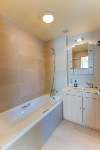 a bathroom with a bath tub and a sink at Villa Vista Almuñécar in Granada