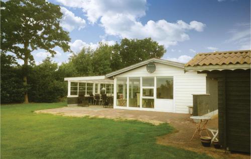 a white house with glass doors and a patio at Holiday Home Lærkevej Vinderup Xii in Vinderup
