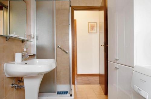 a bathroom with a sink and a shower at Terrassen Wohnung Bacio del Sole in Maccagno Inferiore