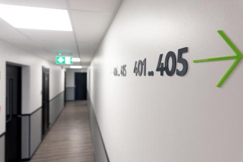 a hallway in a hospital with a sign on the wall at U11 Hotel & SPA in Tallinn