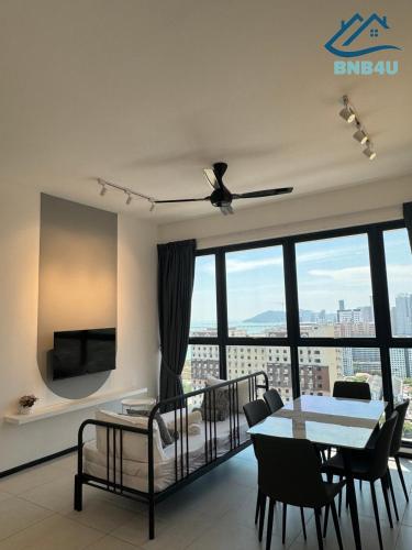 a living room with a ceiling fan and a table at Urban Suites @ George Town Penang by BNB4U in George Town