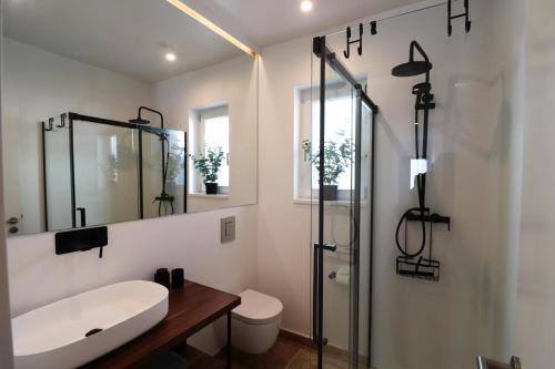 a white bathroom with a sink and a shower at Casa Herzog in Ferragudo