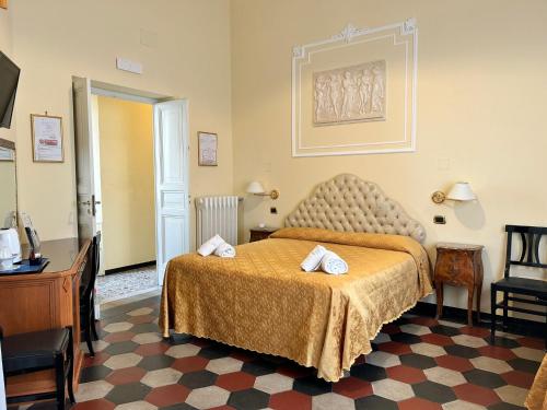 a hotel room with a bed with two towels on it at Hotel Labelle in Rome