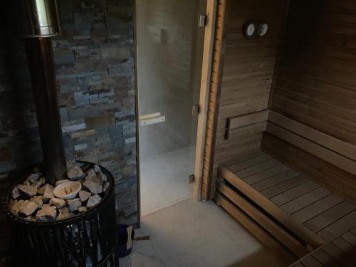 a bathroom with a walk in shower and a trash can at Horský apartmán Zvonička in Rejvíz