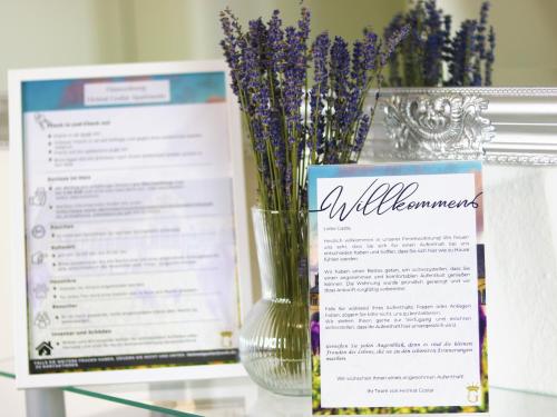 a vase filled with purple flowers on top of a table at Heimat Goslar Apartments "Zur Altstadt" in Goslar