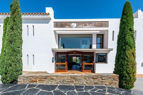 a white building with trees in front of it at Hotel Sol Ixent - Adults Only in Cadaqués