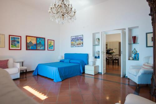 a bedroom with a blue bed and a living room at Beatrice Luxury Apartment in Vietri