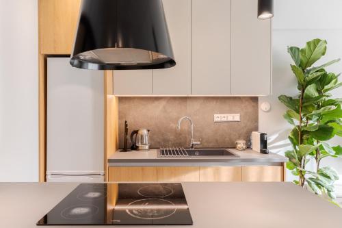 a kitchen with a sink and a stove at #Nereids Apts by halu! Apartments in Thessaloniki
