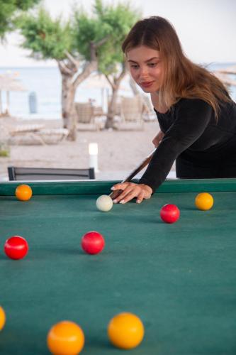 a woman playing pool on a pool table at Sun Beach Lindos in Lardos