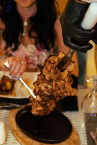 a person preparing a piece of food on a table at Retac Qunay Dahab Resort & SPA in Dahab