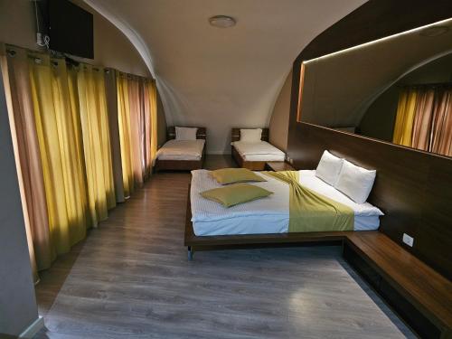 a bedroom with a bed and two chairs in it at HOTEL BENITA in Peje