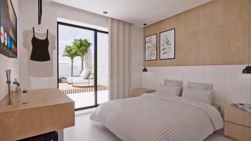 - une chambre avec un lit et une vue sur une terrasse dans l'établissement Kallithea Luxury Villas #4, à Koskinou