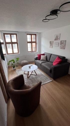 a living room with a couch and a table at Altstadt Oase Fulda in Fulda