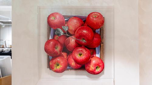 a painting of a bunch of red apples at The Prima Hotel Jongno in Seoul