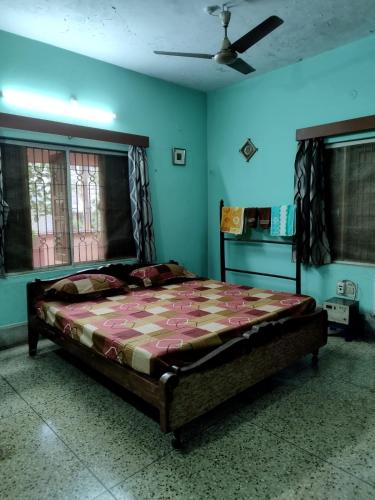 a bedroom with a large bed in a room at Ashiyana in Bhubaneshwar