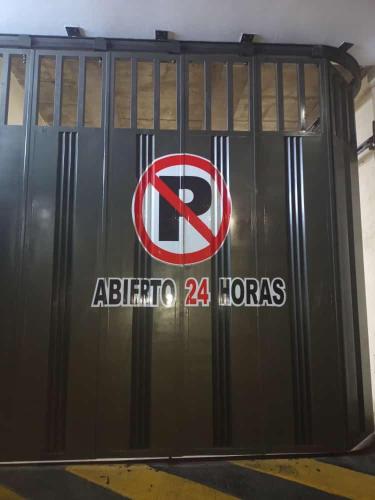 a garage door with a no parking sign on it at Hotel Arci in Cúcuta