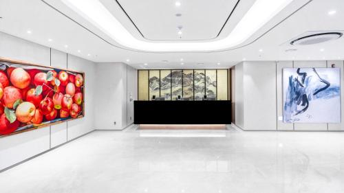 a room with two paintings of apples on the walls at The Prima Hotel Jongno in Seoul
