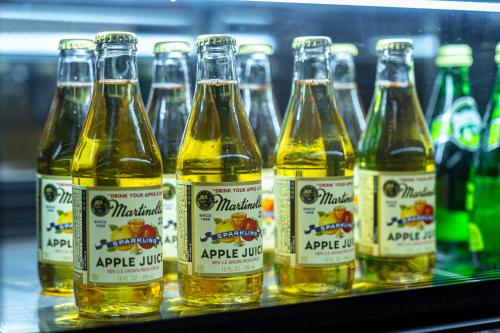 a group of bottles of apple juice on a shelf at The Prima Hotel Jongno in Seoul