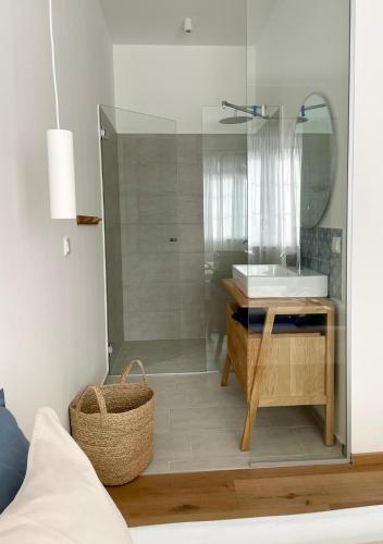 a bathroom with a glass shower and a sink at Pannonia Apartments in Mörbisch am See