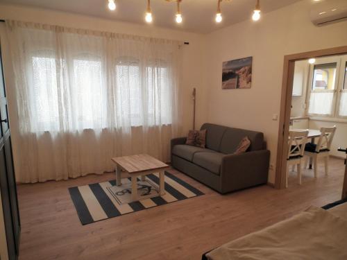 a living room with a couch and a table at Appartement blue Dinghi in Mörbisch am See
