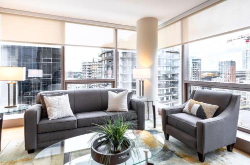 ein Wohnzimmer mit 2 Sofas und einem Glastisch in der Unterkunft Spacious Apartment Downtown in Stamford