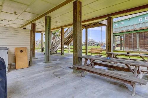 an empty building with wooden pillars and benches in it at Just Beachin’ It in Bolivar Peninsula