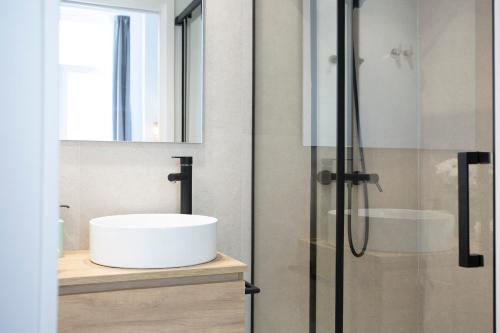 a bathroom with a white sink and a shower at SingularStays Mercado Central in Valencia