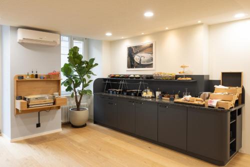 a bakery with a counter with food on it at Fred Guest House Hauptbahnhof - Mobile Check-in in Zürich