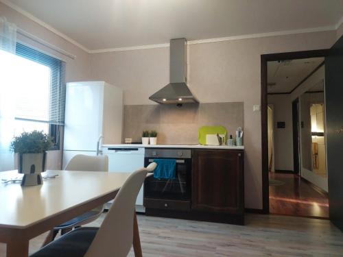 a kitchen with a table and a stove top oven at Øren apartment in Drammen