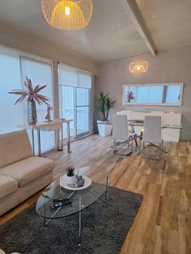 a living room with a couch and a table at Garden House in São Vicente Ferreira