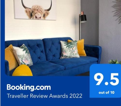 a blue couch with pillows in a living room at Coventry Cosy House, City Centre, Free Parking, Sleeps 5, by EMPOWER HOMES in Coventry