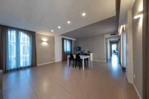 a living room with a table and chairs at Airone City Hotel in Catania