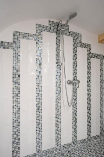 a bathroom with a shower with tiled walls at Casa Gemma in Rimella