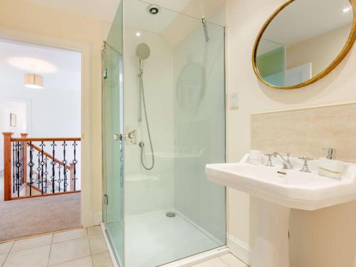 a bathroom with a shower and a sink and a mirror at 4 Bed in Montrose 89698 in Brechin