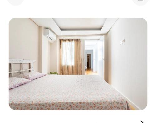 um quarto com uma cama grande e uma janela em Oasis de Valencia em Valência