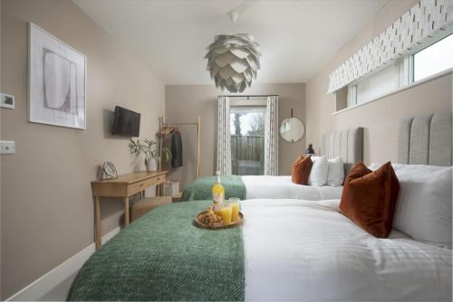 a bedroom with a white bed with a green rug at Salt Life, Dunes at Upton Towans in Hayle