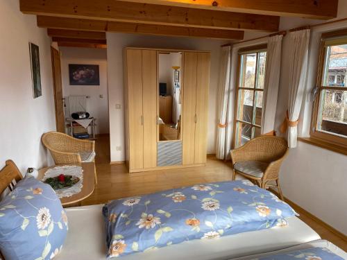 a bedroom with a bed with a blue comforter at Apartment Landhaus Bachwinkl in Reit im Winkl