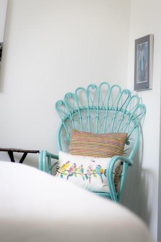 a blue chair with a pillow on top of it at The Barns of Brighton Near Prince Edward County in Brighton