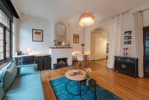 a living room with a couch and a table at Fish Market Apartments in Brussels